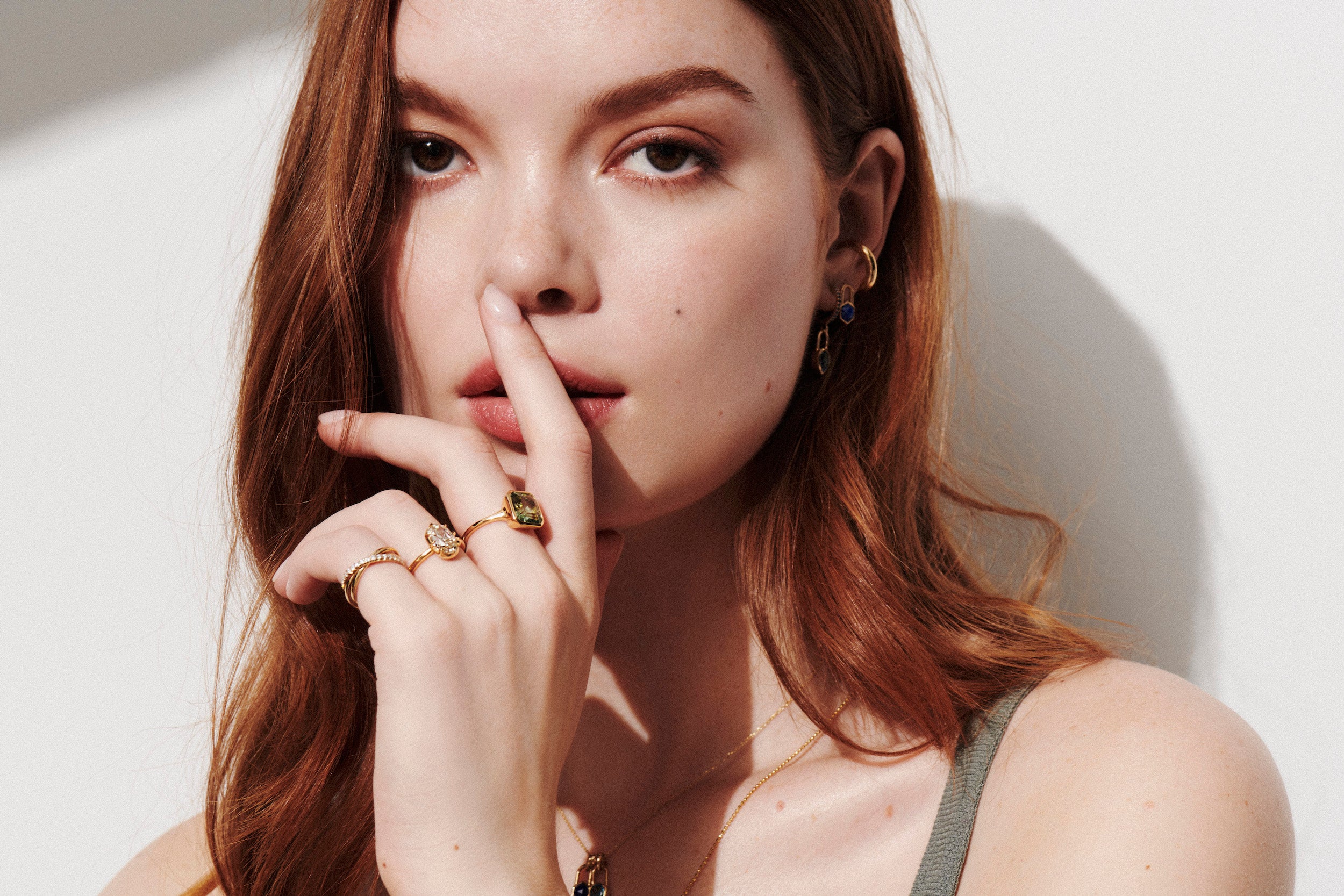 Model wearing the Vale Jewelry Hexagon Lapis Lazuli Lock Earrings in Yellow Gold