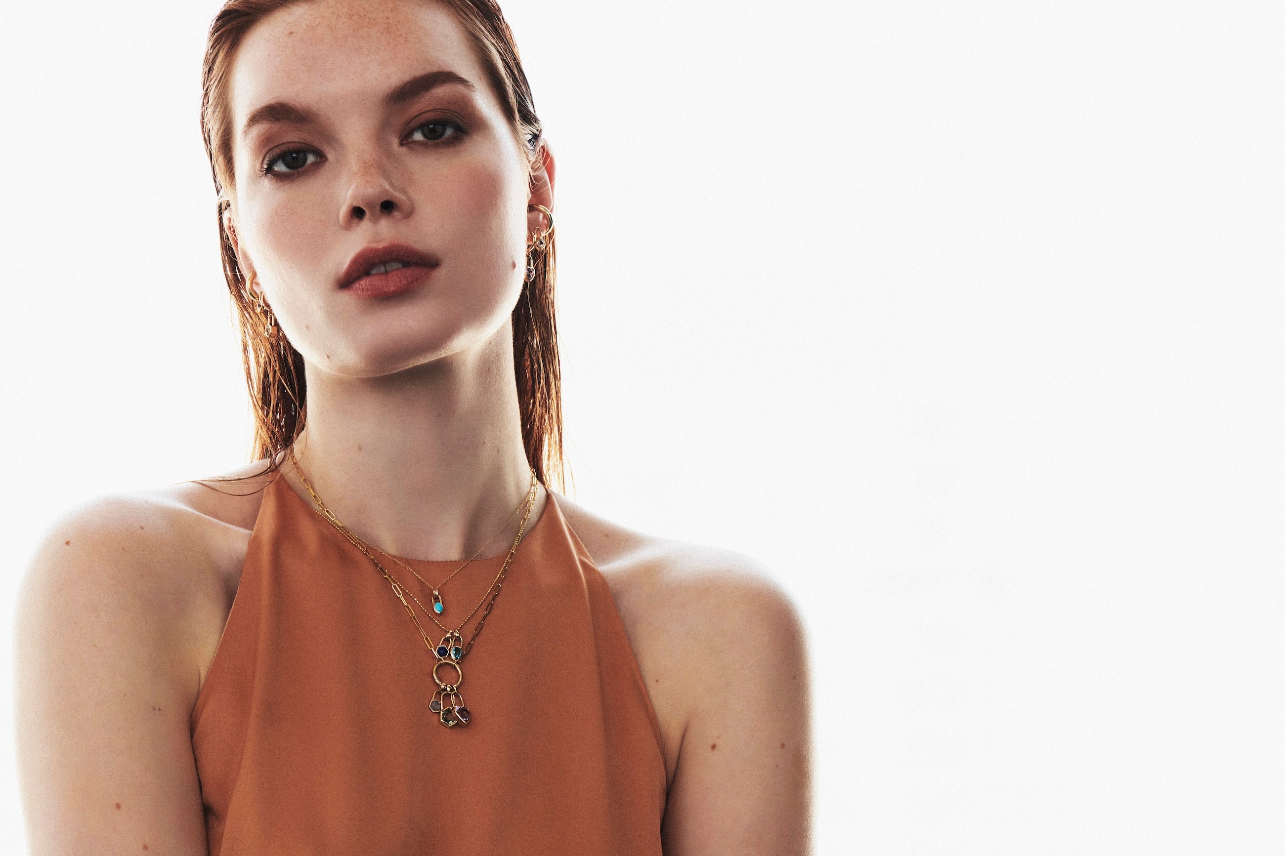 Model wearing necklaces from Vale Jewelry