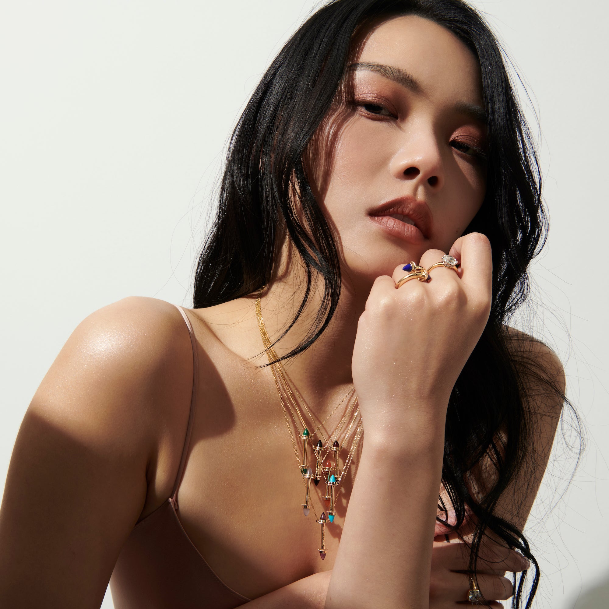 Model wearing a stack of Amphora Scroll Coup de Foudre Necklaces