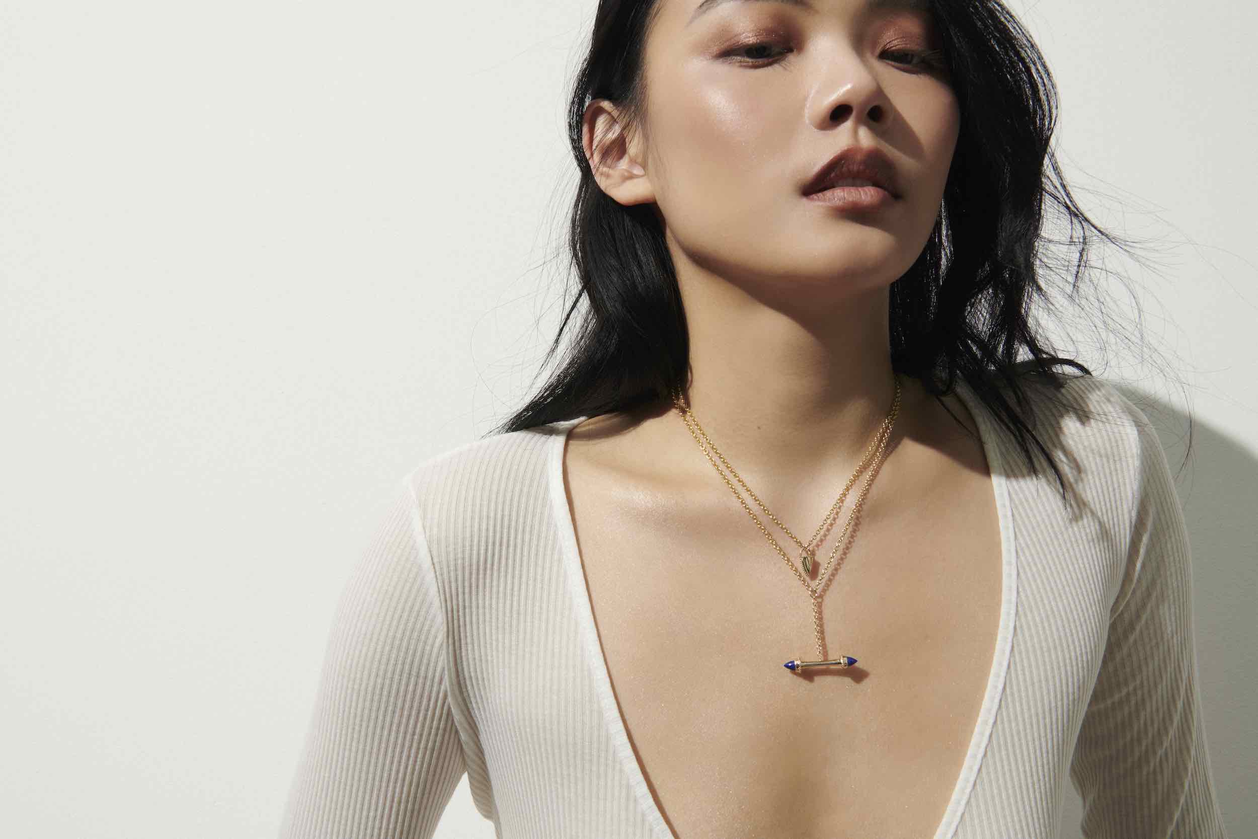 Model wearing the Amphora Scroll Y-Necklace Lapis Yellow Gold