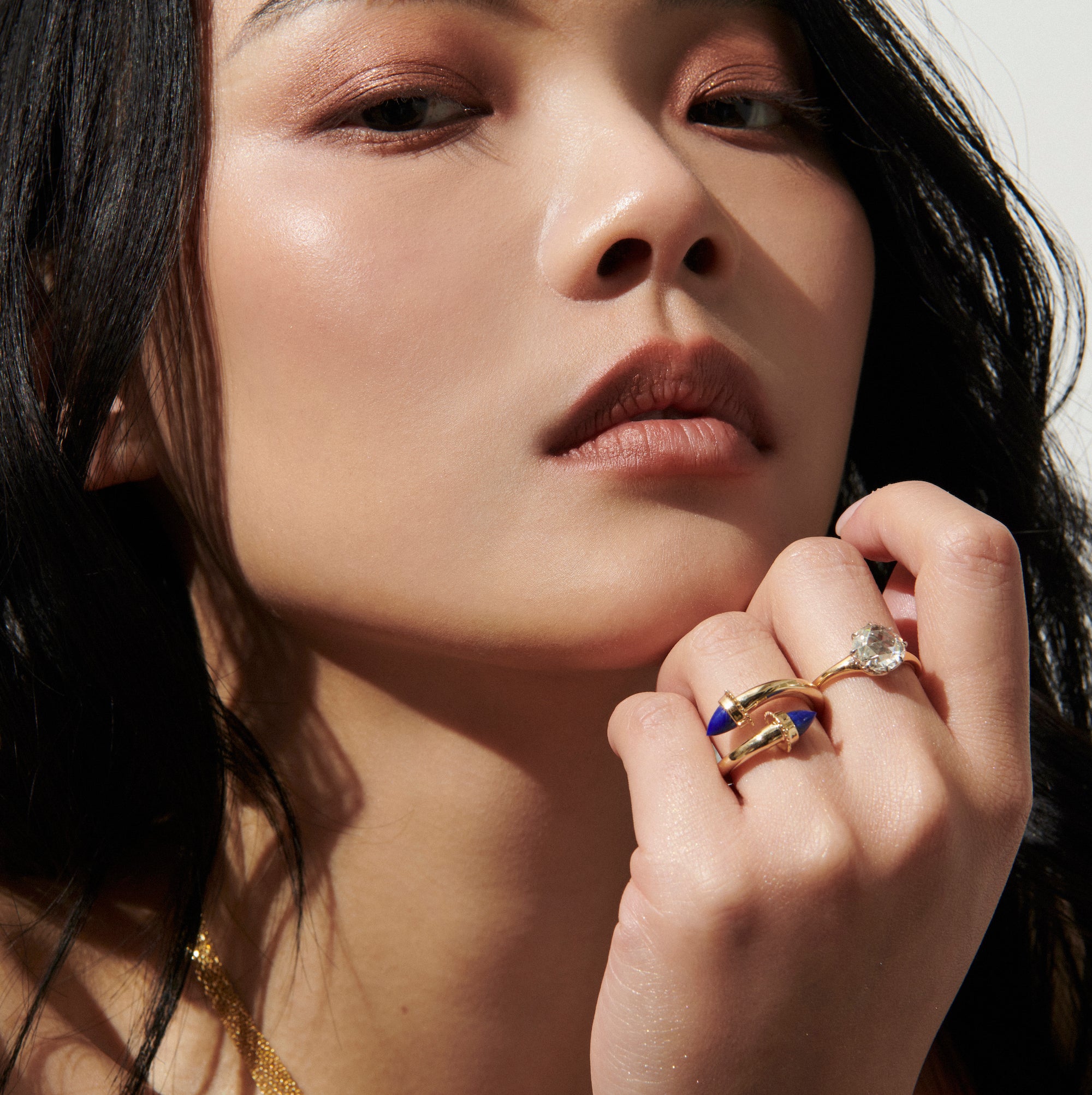 Model Wearing Large Round Rose Cut Diamond Ring and Amphora Twist Ring with Garnet from Vale Jewelry