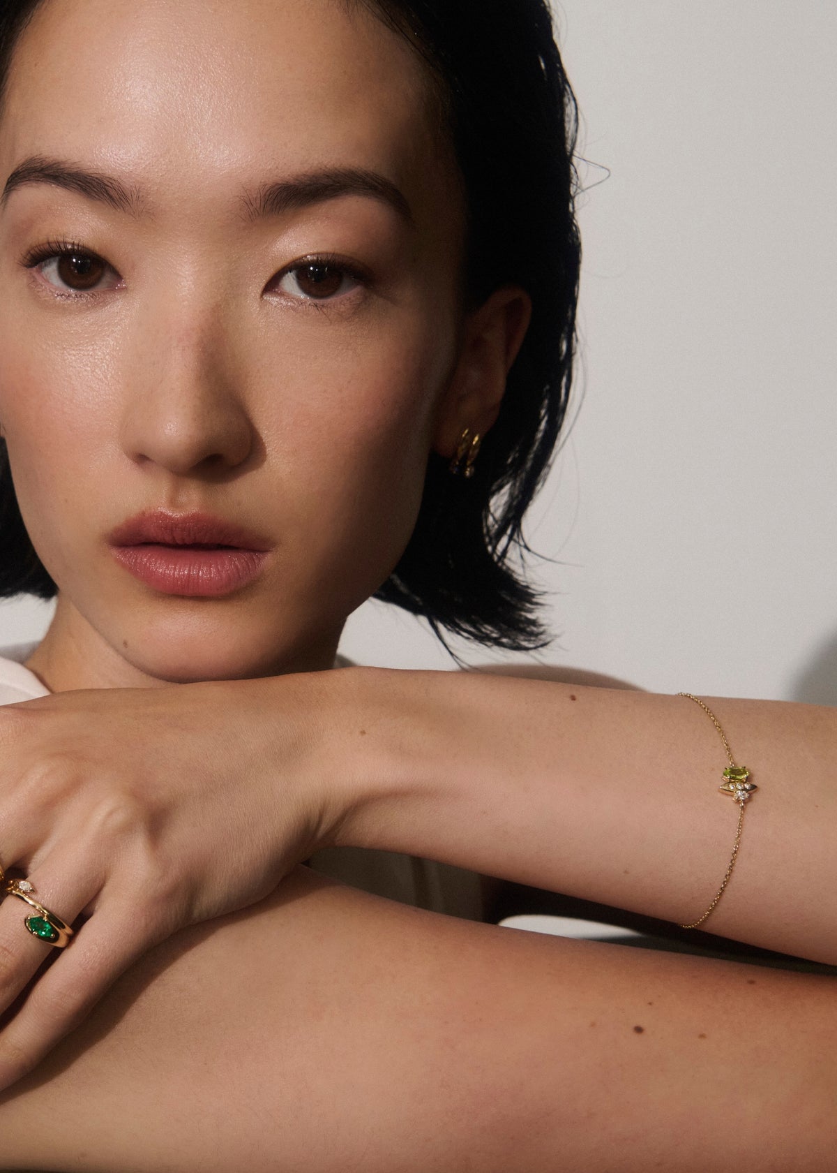 Alt="Vale Jewelry Rainfall Triple Marquise Peridot Bracelet worn on model with hand placed on her shoulder"