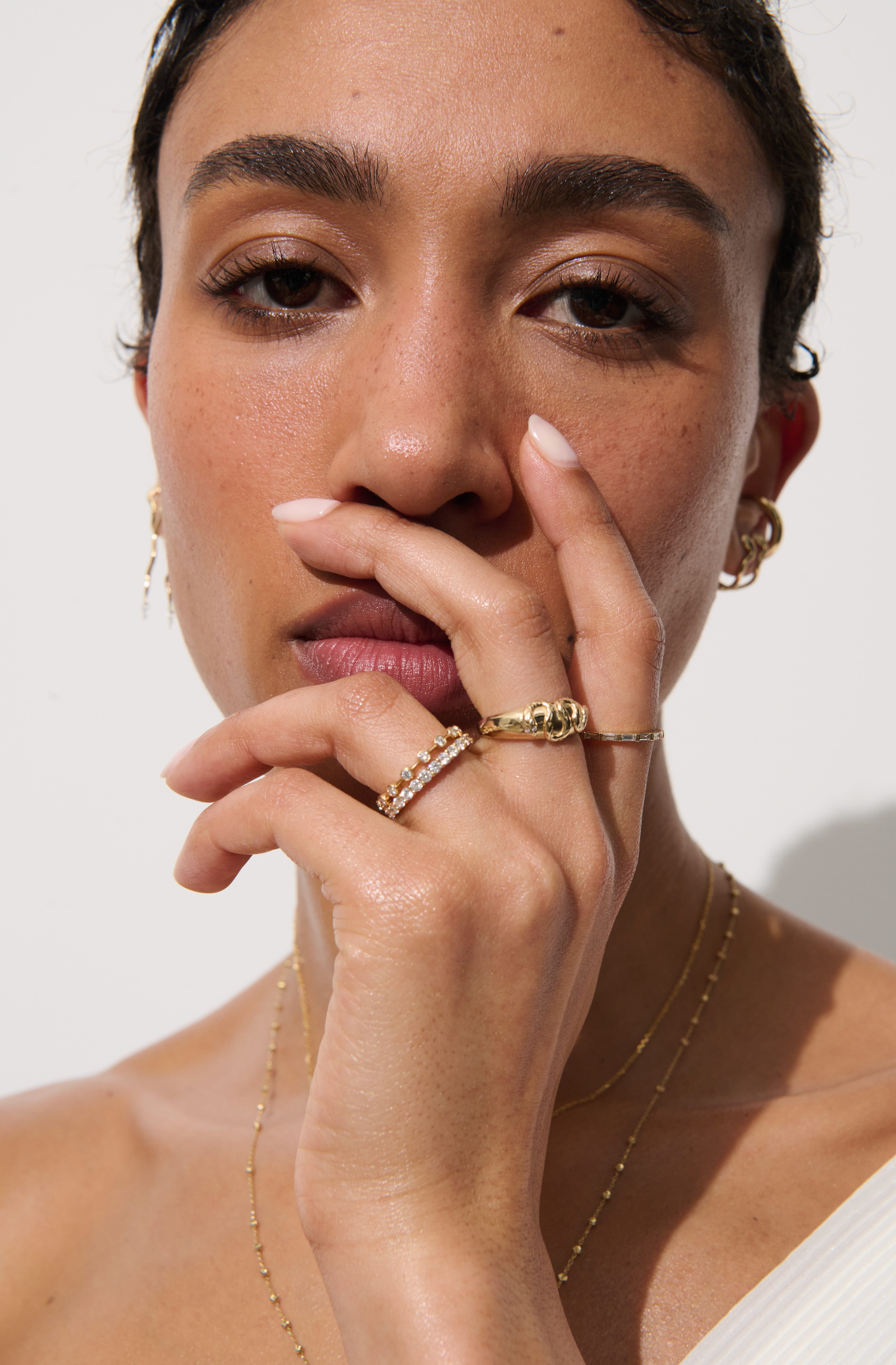 Model wearing a stack of rings, including the Vale Jewelry Allie Ring