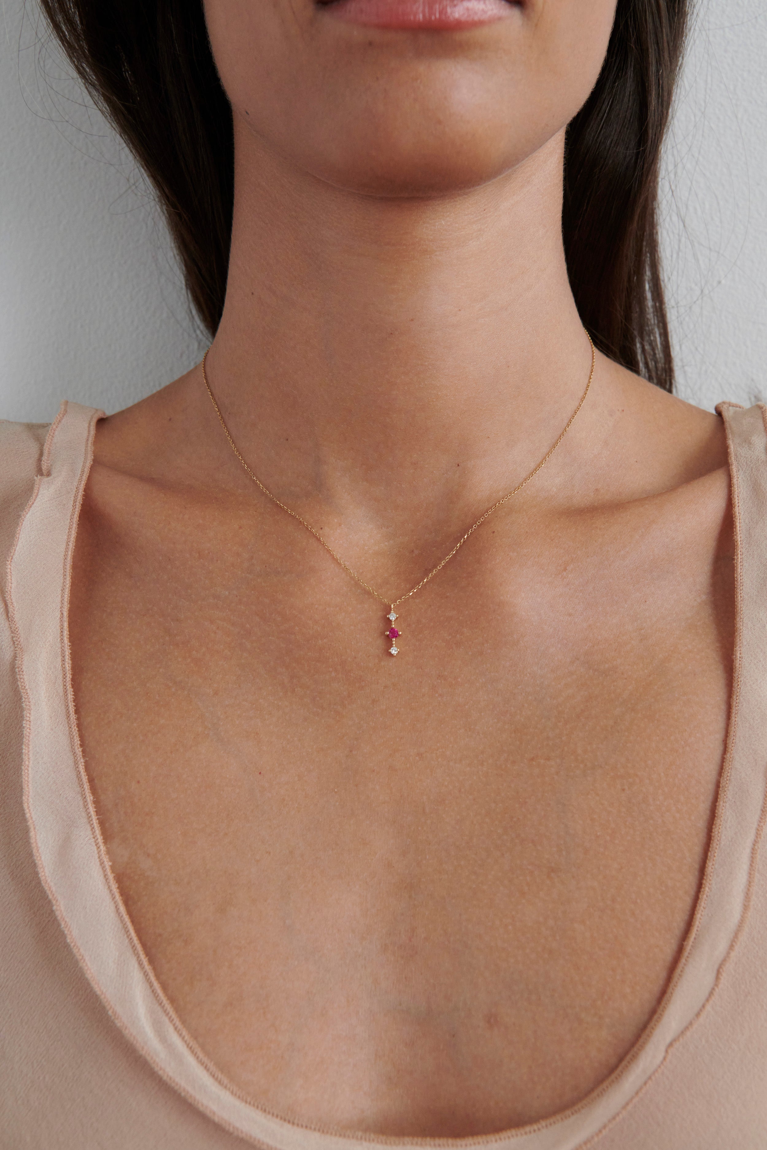Close-up of Model Wearing Vale Jewelry Celeste Bar Necklace with Ruby and Diamonds
