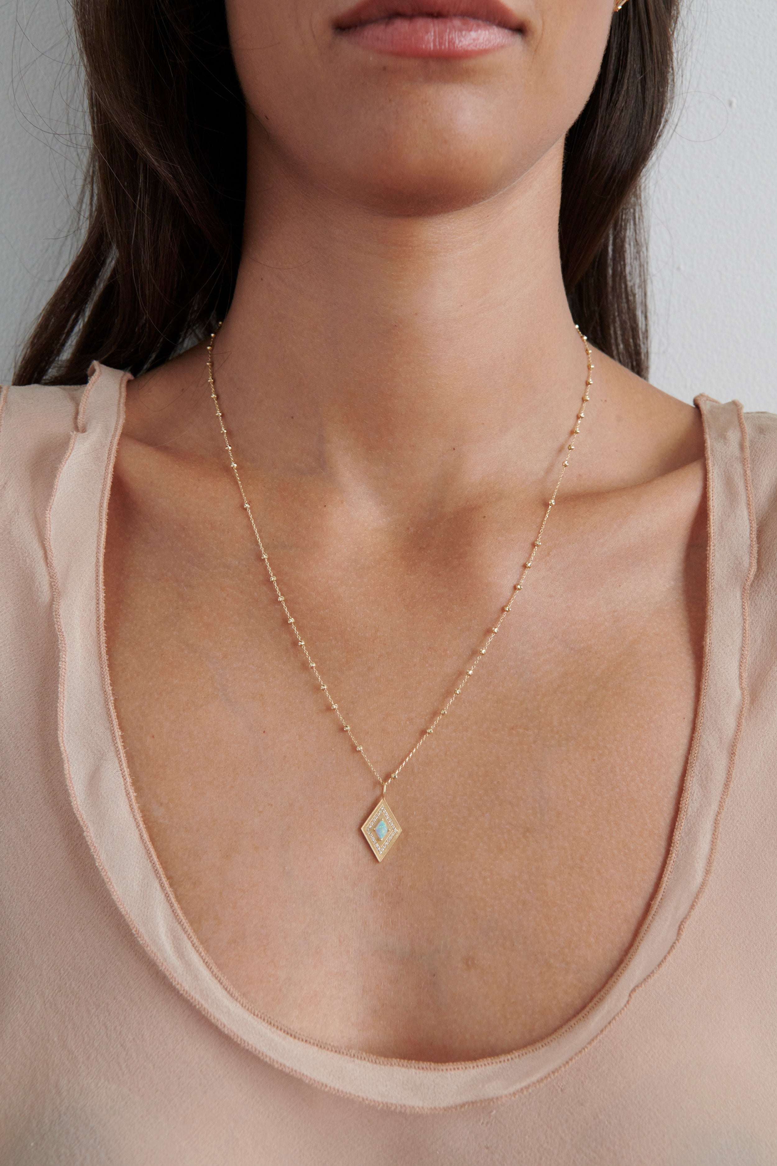 Close-up of Model Wearing Vale Jewelry Large Theodora Necklace with Opal
