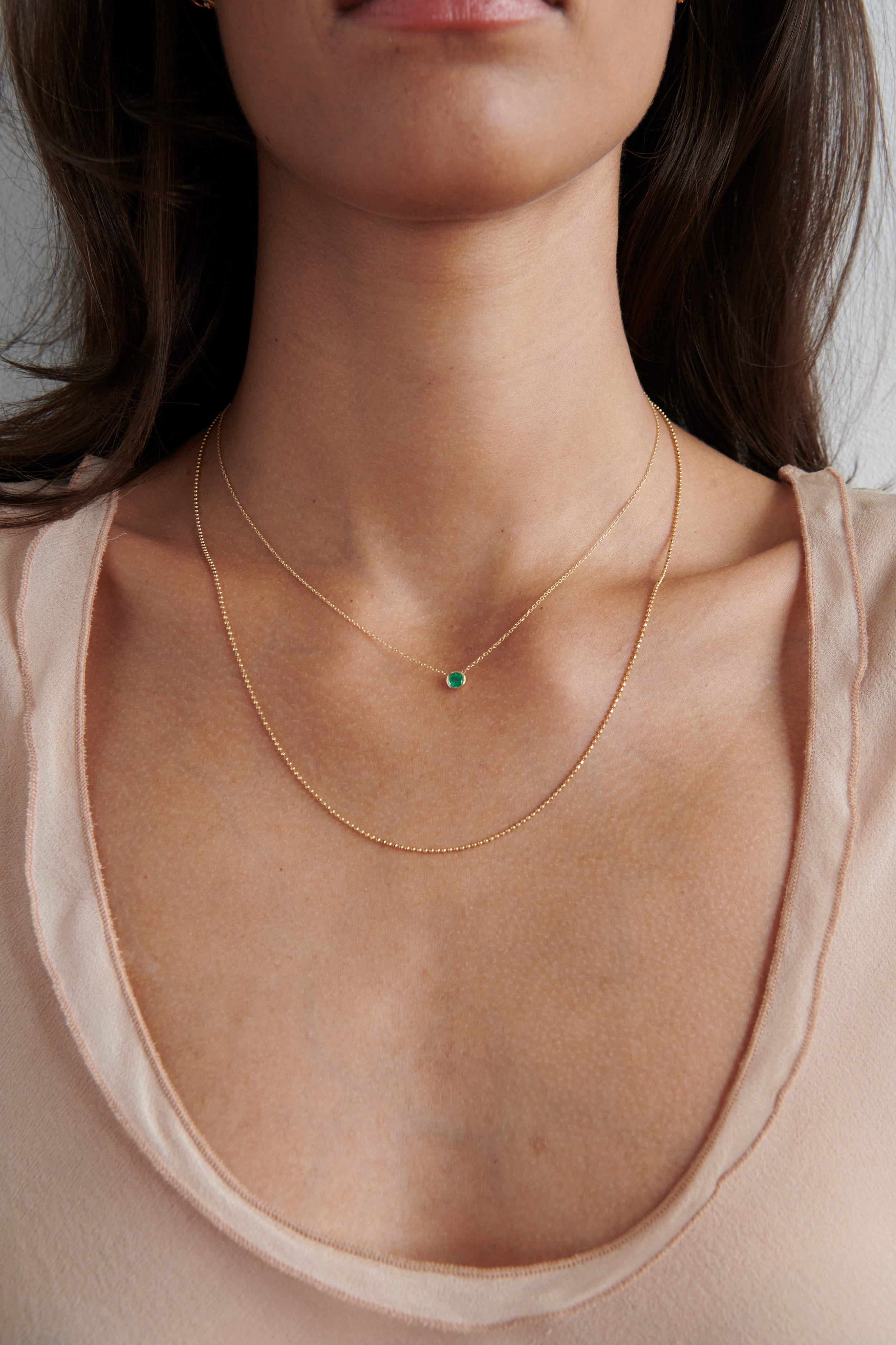 Model Wearing Vale Jewelry Medium Barely There Emerald Necklace with Faceted Bead Chain Necklace