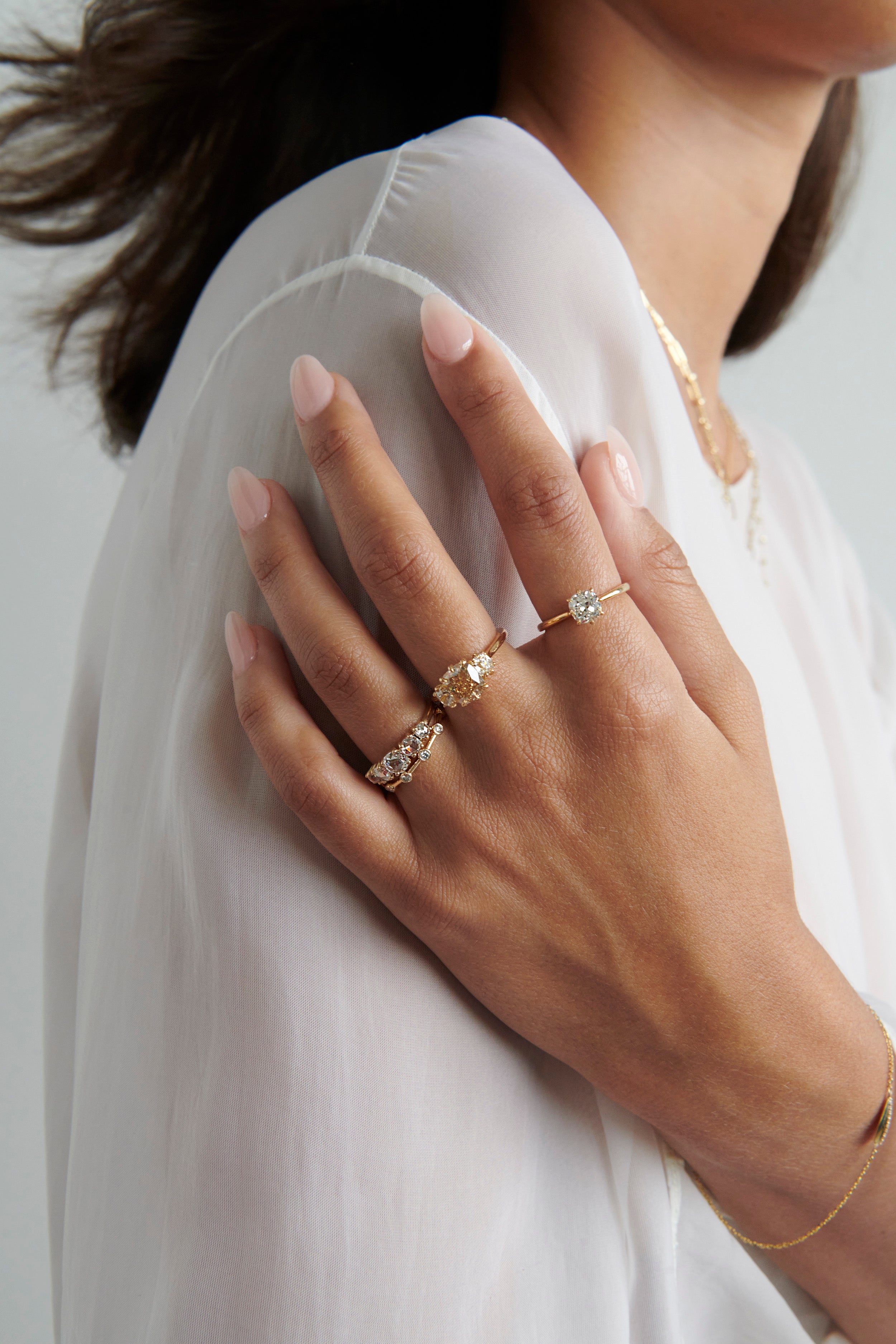Close-up of Model Wearing Vale Jewelry Moonlet Ring with White Diamonds Stacked with Farren Ring