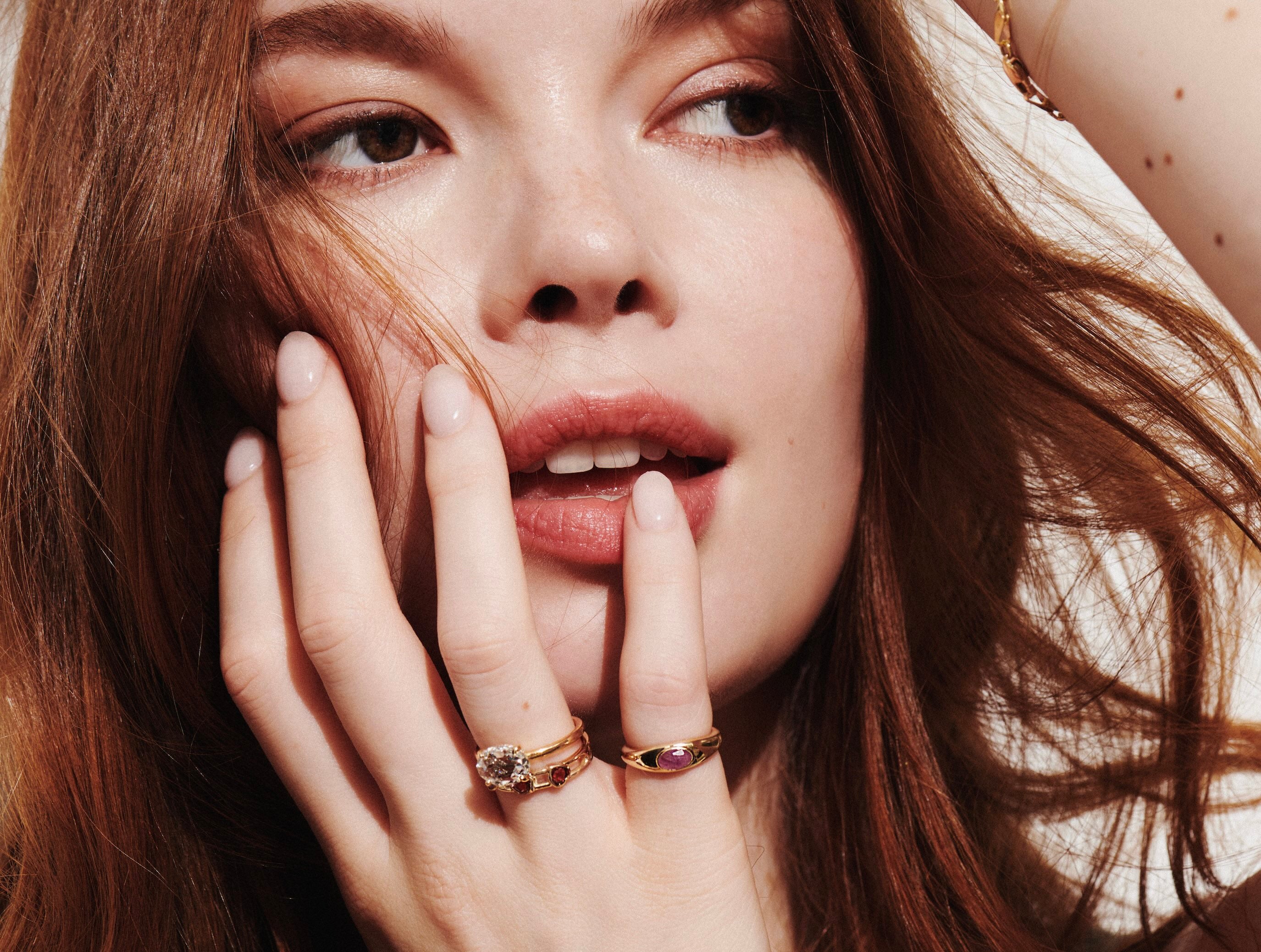 Model Wearing Mixed Shape Multi-Stone Open Band Lock Ring, Tommy Ring with Pink Sapphire, and One-of-a-Kind 1.43 Carat East-West Oval Rose Cut Diamond Ring