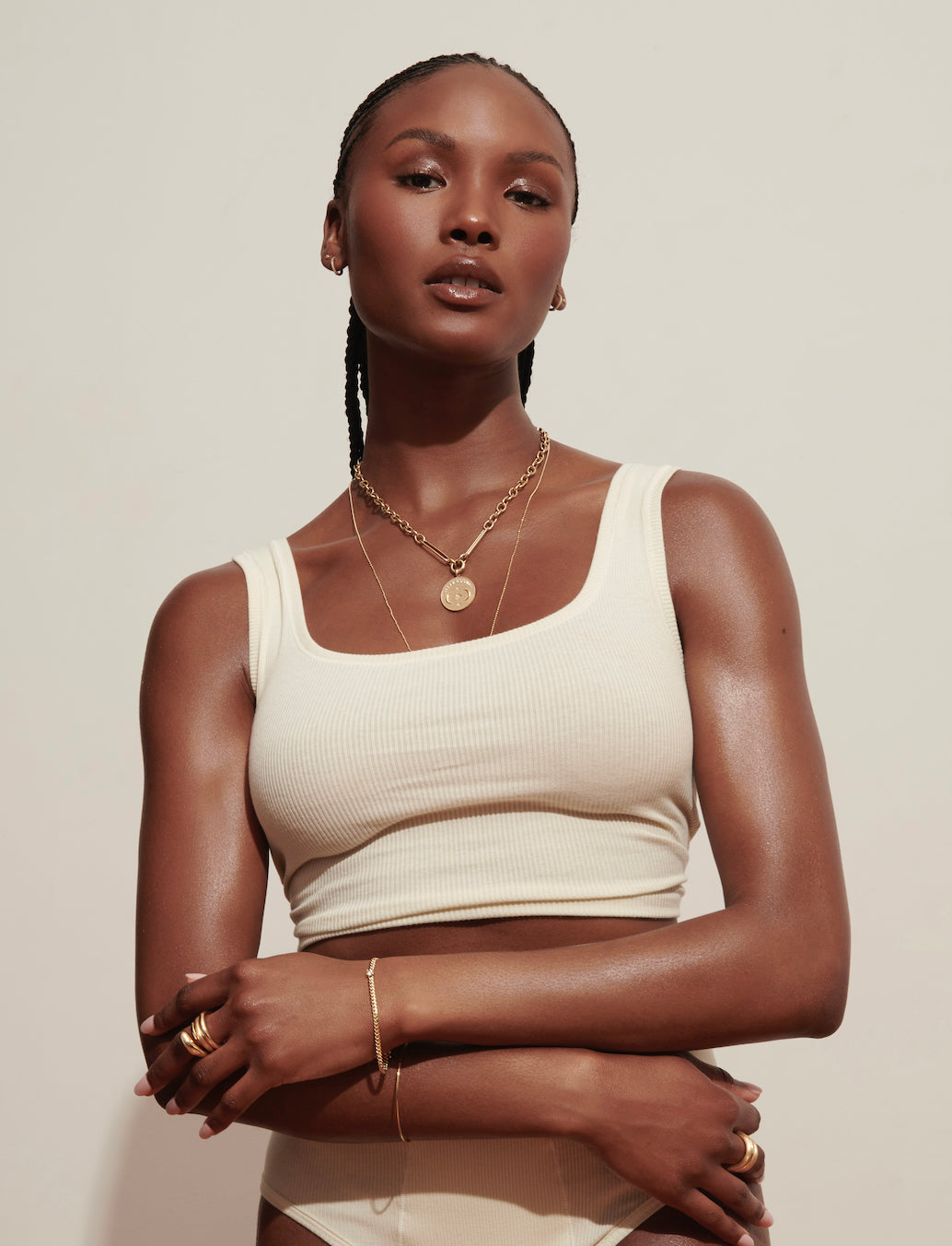 Model Wearing Large Gold Disc Evelyne Necklace with Stacked Chunky Gold Bands and Marnie Curb Chain Bracelet from Vale Jewelry