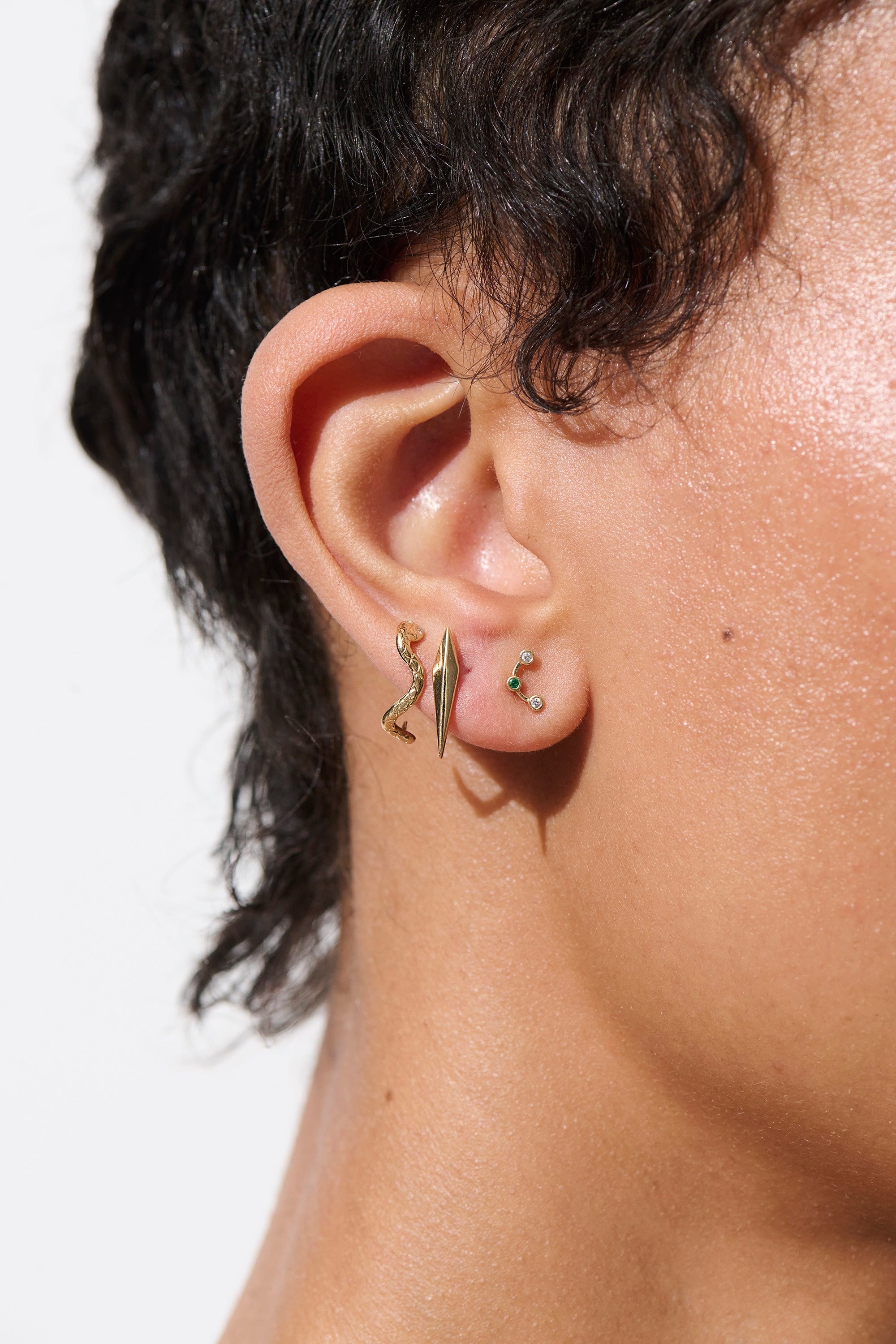 Alt="Vale Jewelry model Wearing Vale Jewelry Eternals Textured Serpent Half Loop Earrings"