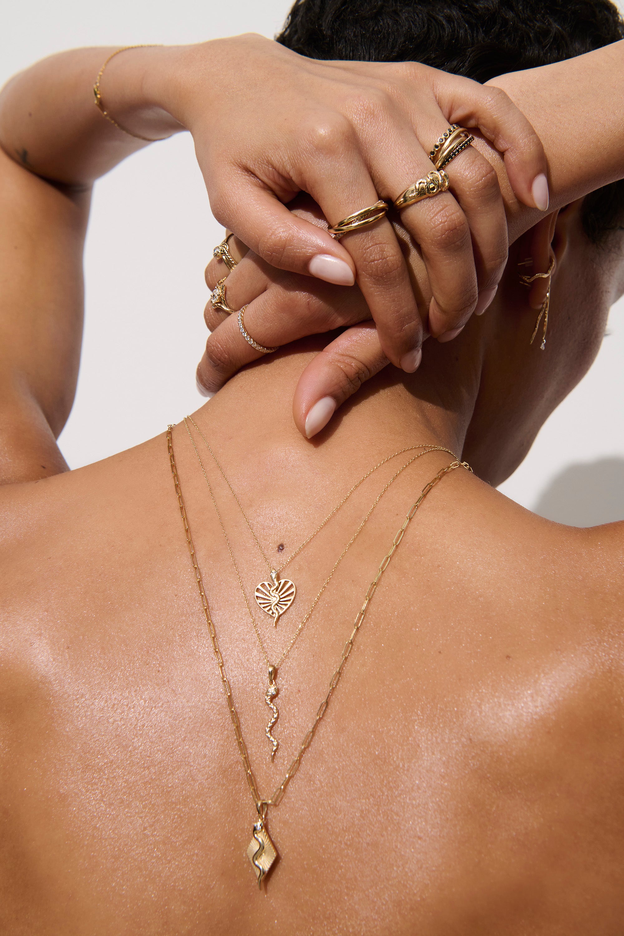 Alt="Vale Jewelry Model facing away with textured serpent necklace on backwards"