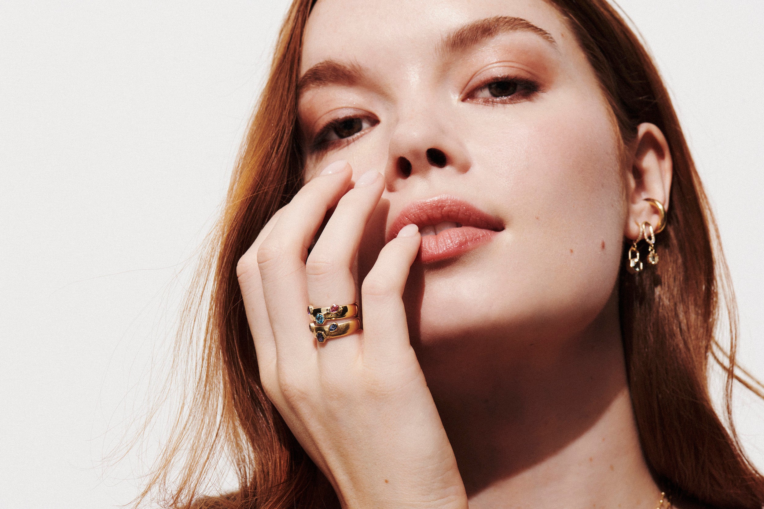Model wearing the Vale Jewelry Hexagon Lock Prasiolite & White Diamond Huggie Earrings in Yellow Gold