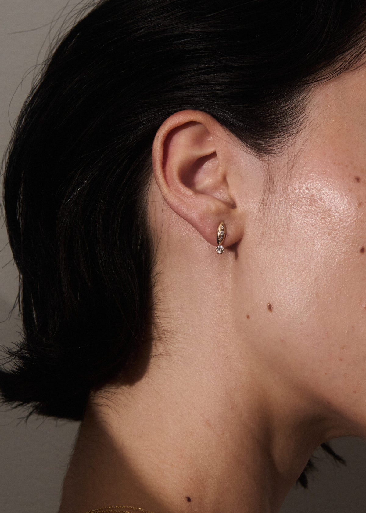 Alt="Vale Jewelry Rainfall Marquise Earrings with Round Diamonds Yellow Gold worn on model ear Close Up"
