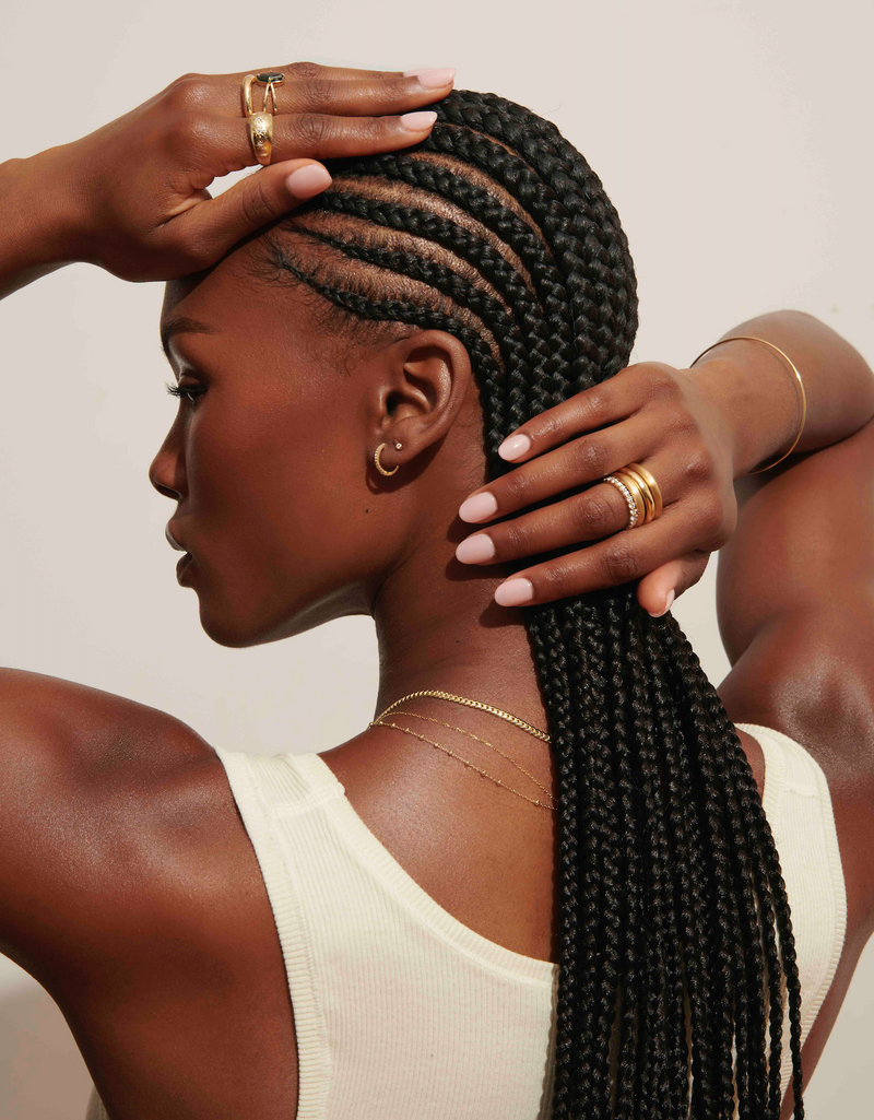 Model Wearing Thin Gold Quotiden Bangle and Stack of Chunky Gold Rings and Allie Eternity Diamond Ring from Vale Jewelry