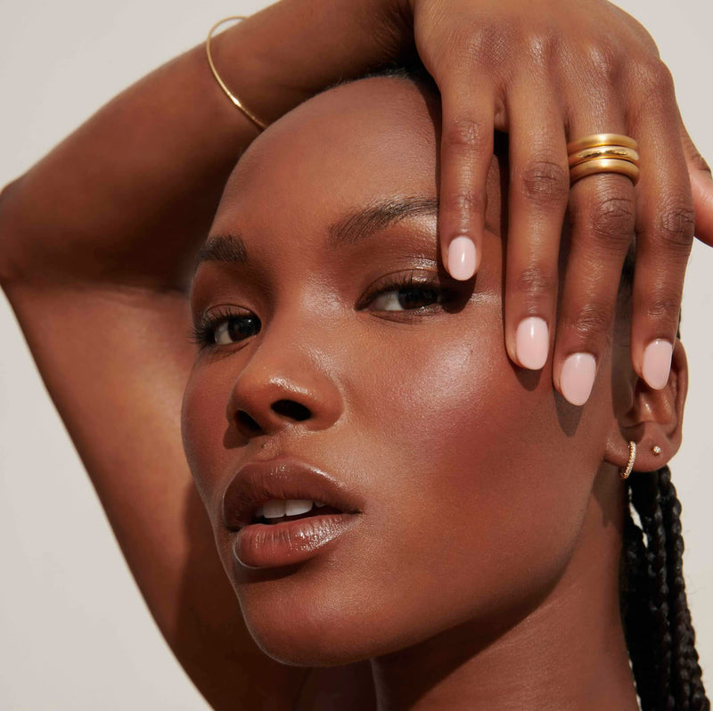 Model wearing rings, earrings, and bracelet from Vale Jewelry 