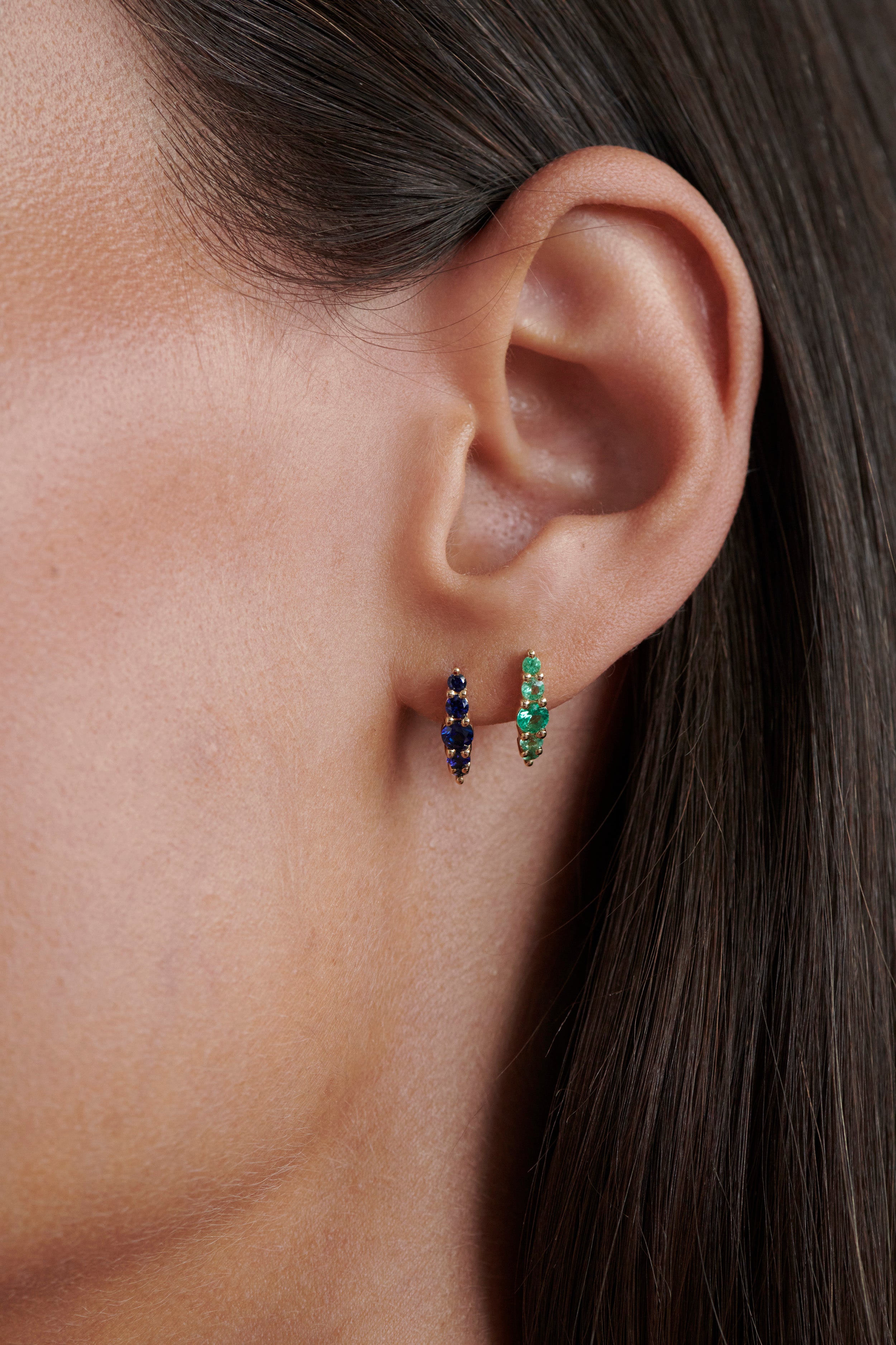 Alt="Vale Jewelry Emerald Belle Du Jour Earrings and Belle Du Jour earrings with blue sapphires in yellow gold on model"