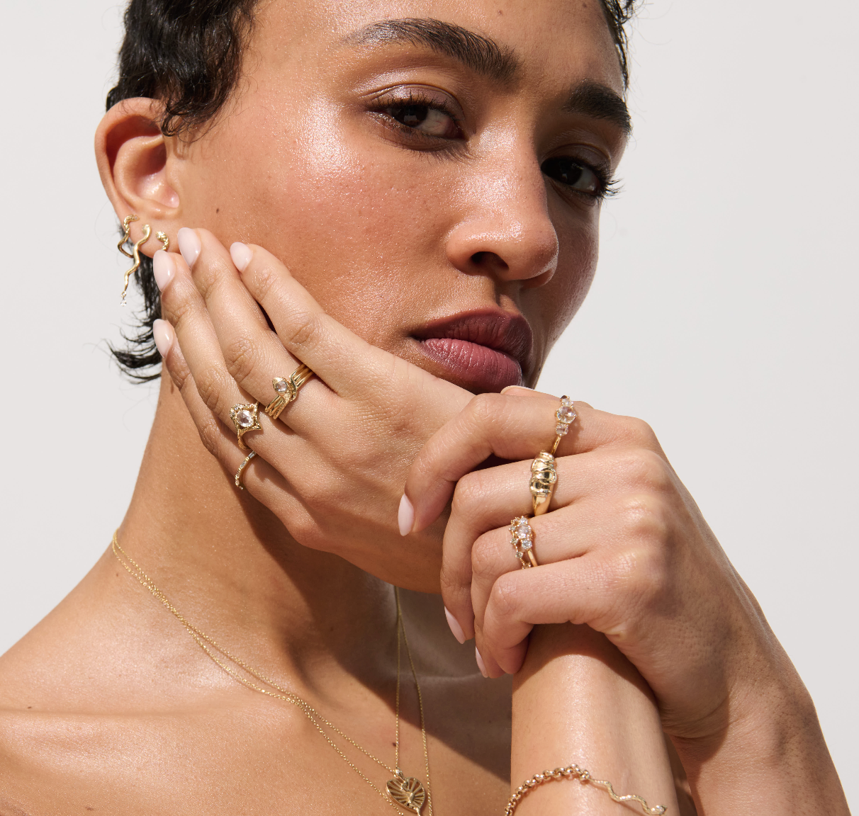 Model Wearing Celeste Ring from Vale Jewelry in Yellow Gold Stacked with Other Gold Rings