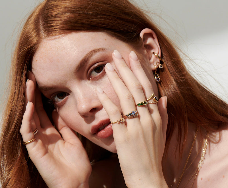 Side View of Model with Hands to Chin Wearing Heart Lock Amethyst Huggie Earrings, Square Morganite Lock Earrings, Jude Round Ear Cuff from Vale Jewelry