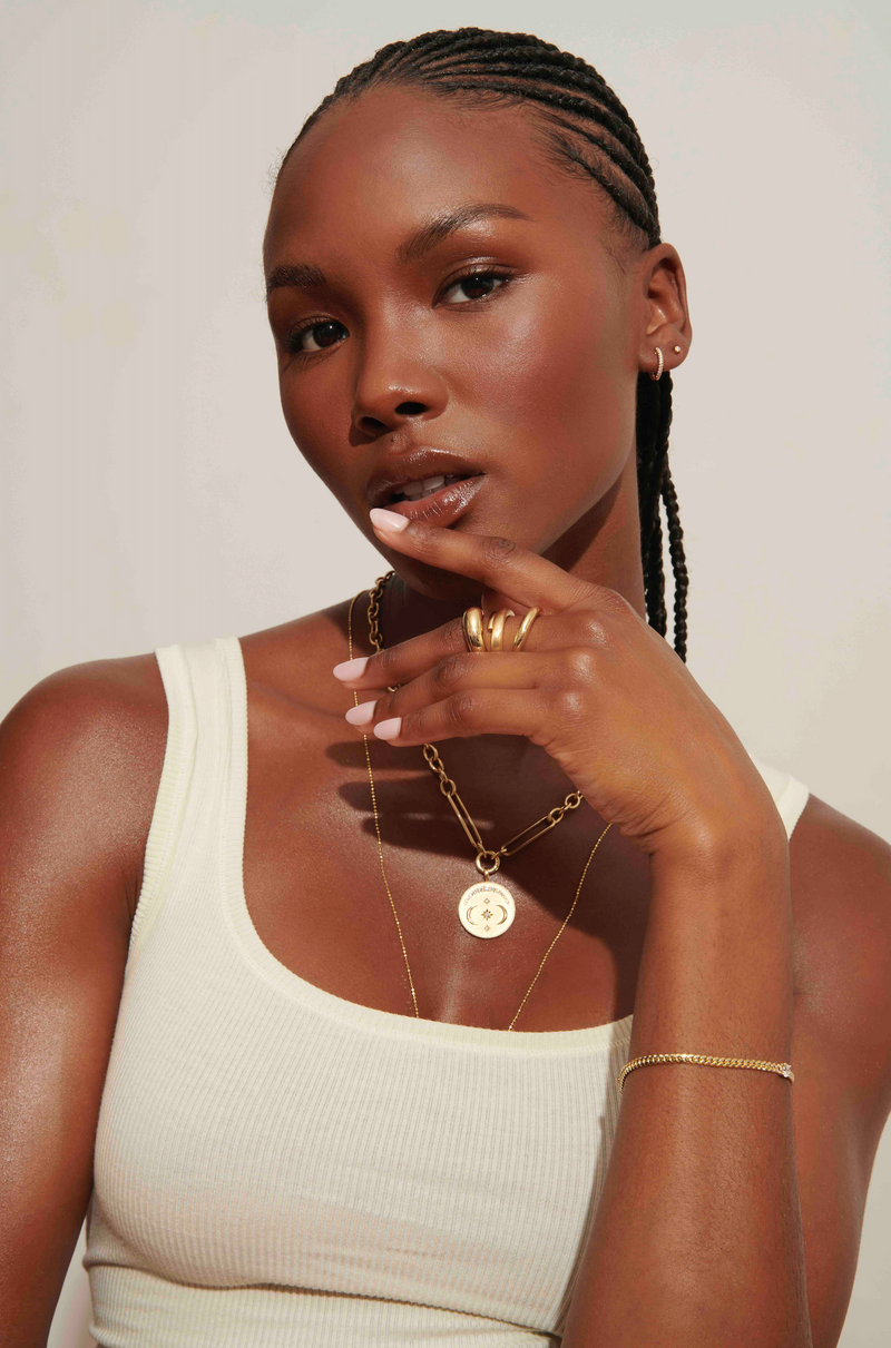 Model Wearing Gold Disc Evelyne Necklace with Chunky Chain and Curb Marnie Bracelet with Stacked Gold Bands from Vale Jewelry