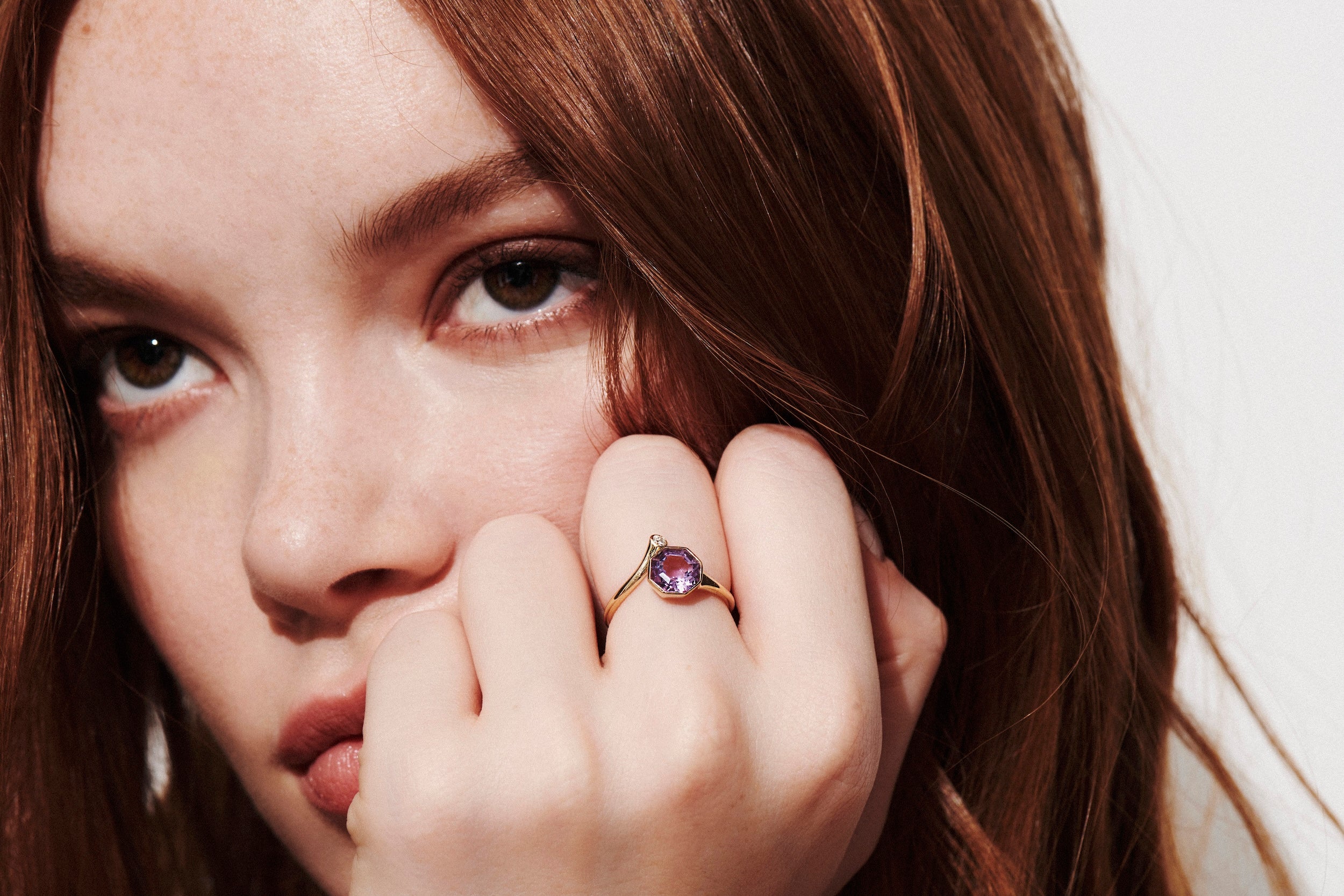 Model with Hand to Face Close-up Wearing Amethyst Octagon and Diamond Wrap Lock Ring from Vale Jewelry