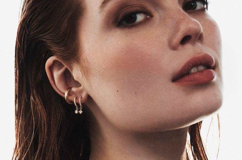 Model Wearing Pavé Huggie with Round Diamond Charm with Jude Ear Cuff from Vale Jewelry