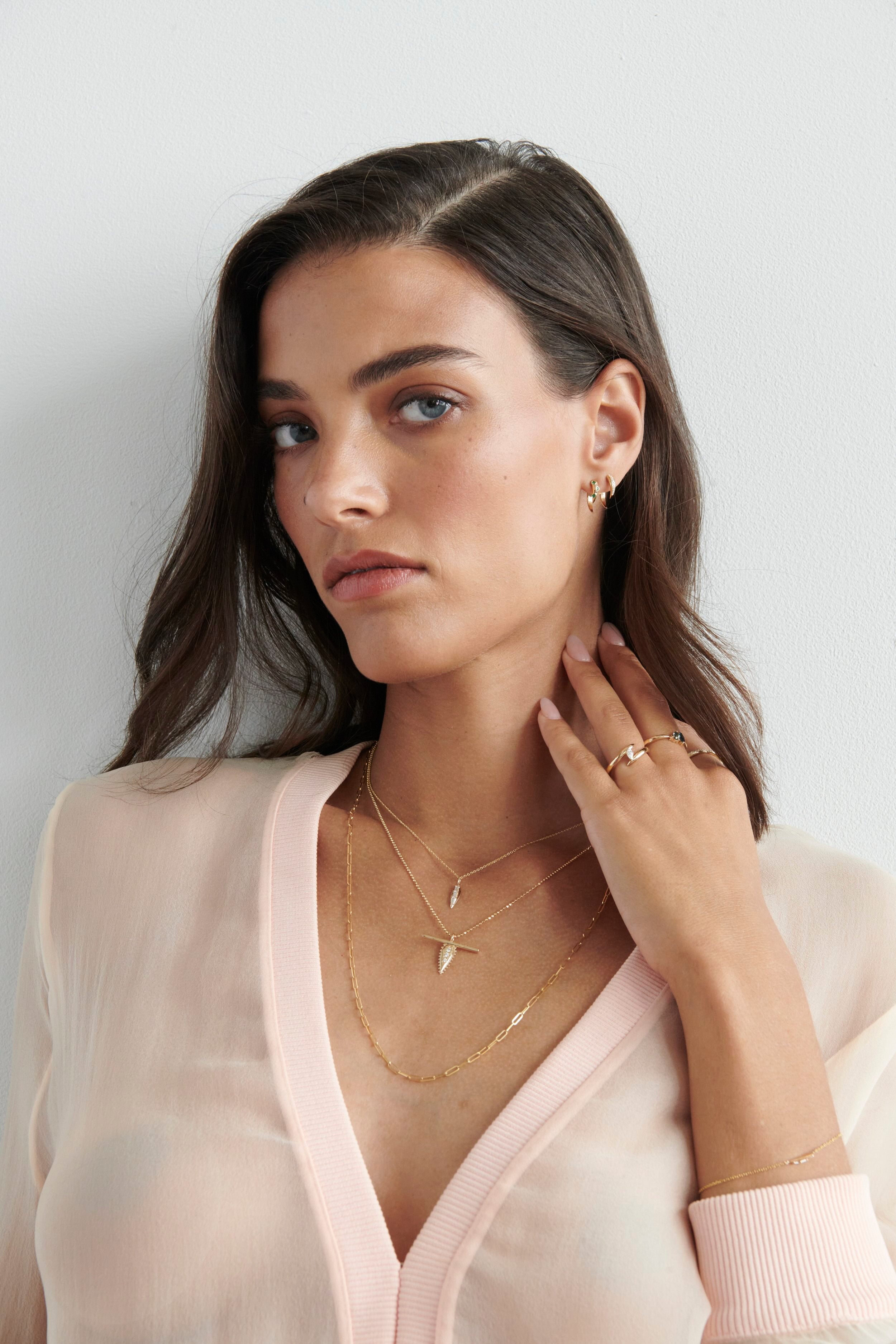 Close-up of Model Wearing Vale Jewelry Swoop Emerald 2-Piece Earrings