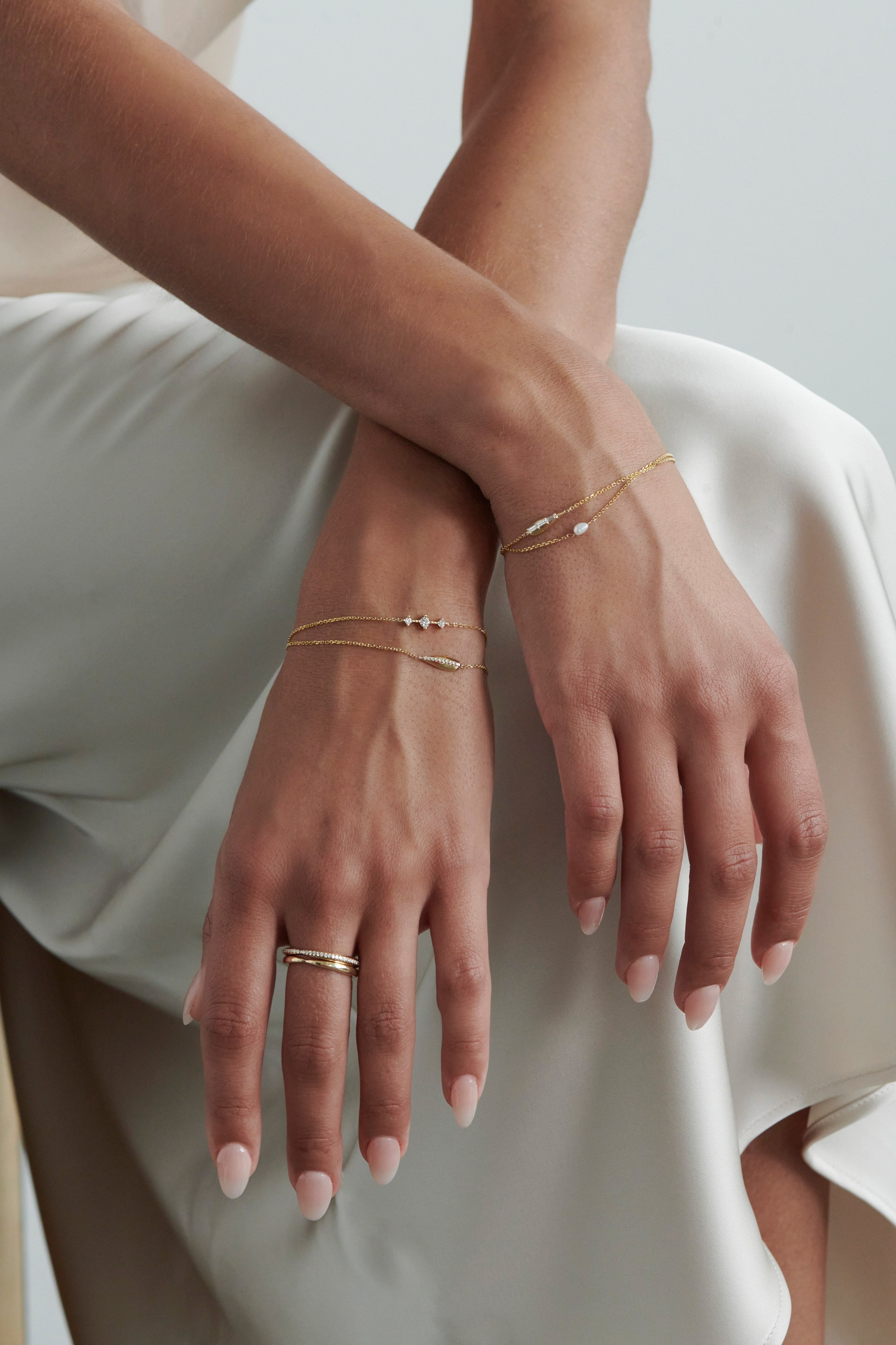Model Wearing Vale Jewelry Swoop Kiss Ring with Multiple Gold Rings