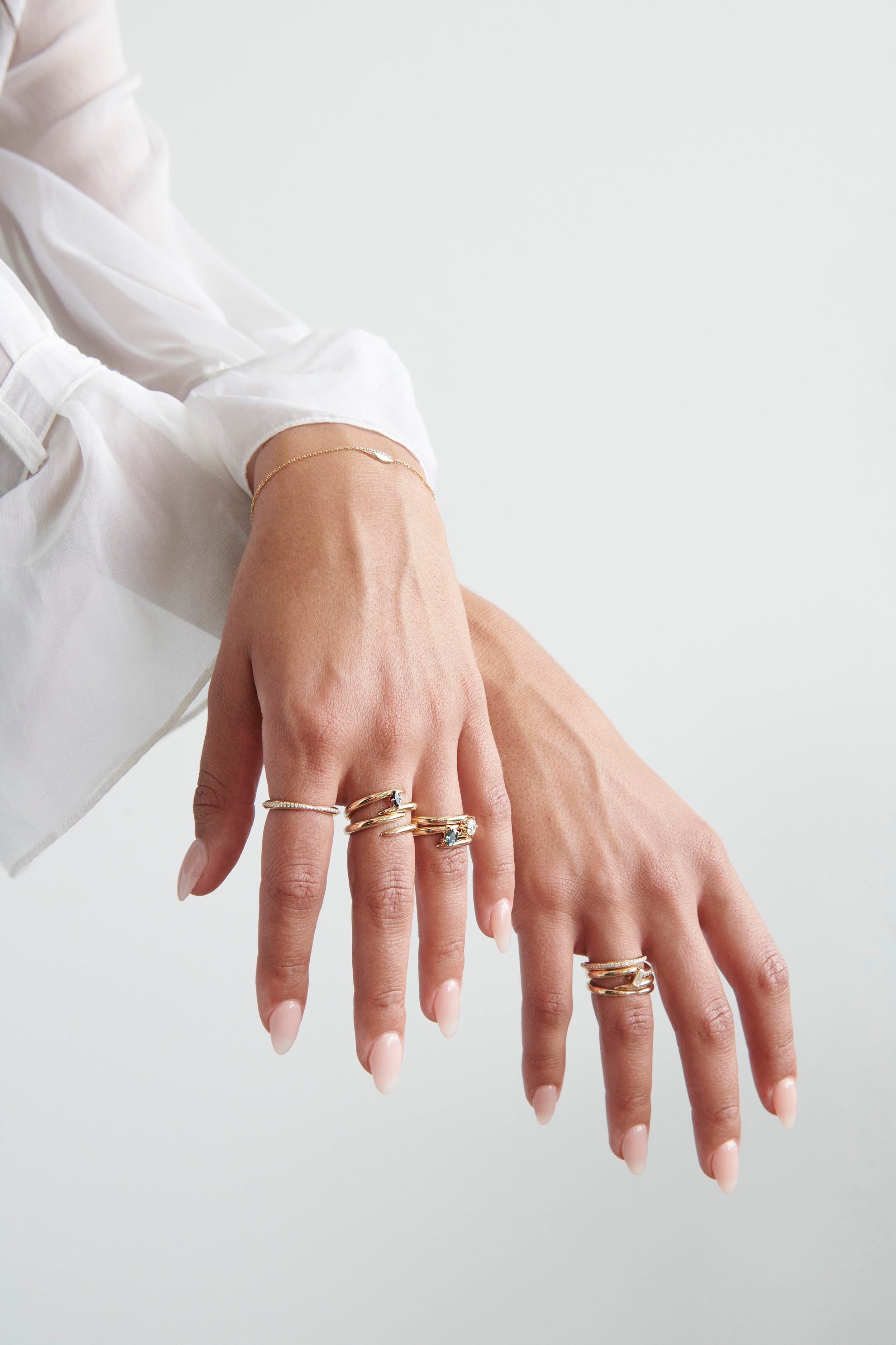 Model Wearing Vale Jewelry Swoop Kiss Ring with Multiple Gold Rings