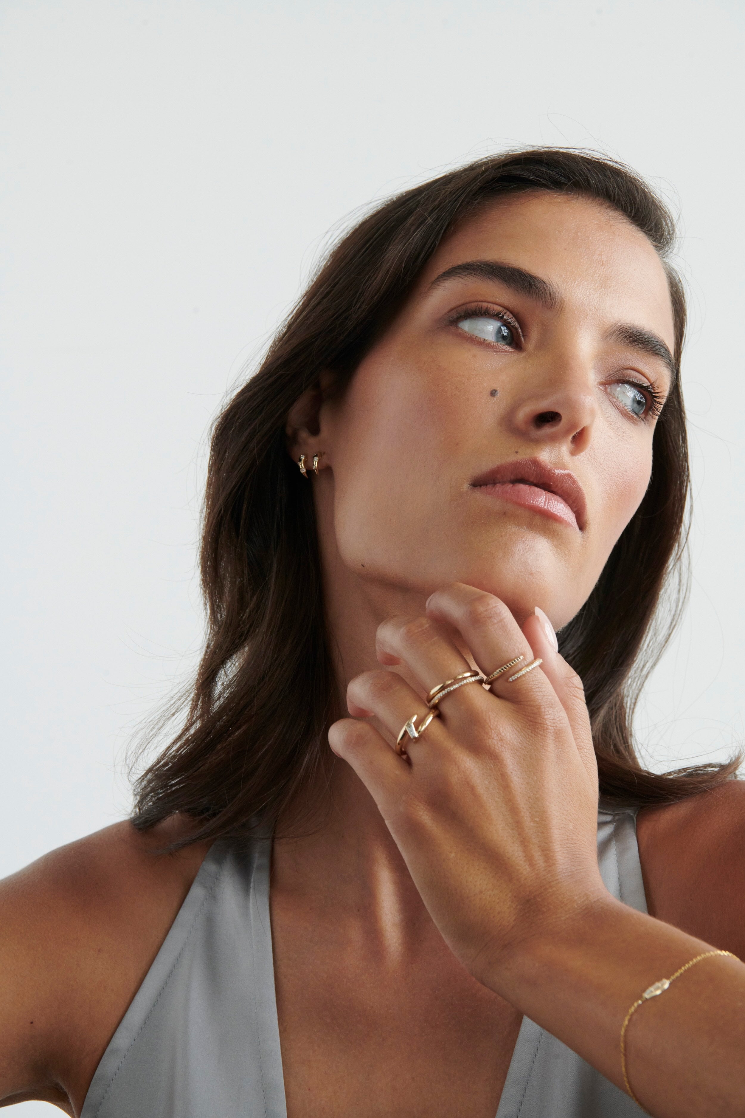 Model Wearing Vale Jewelry Swoop Kiss Ring with Multiple Gold Rings