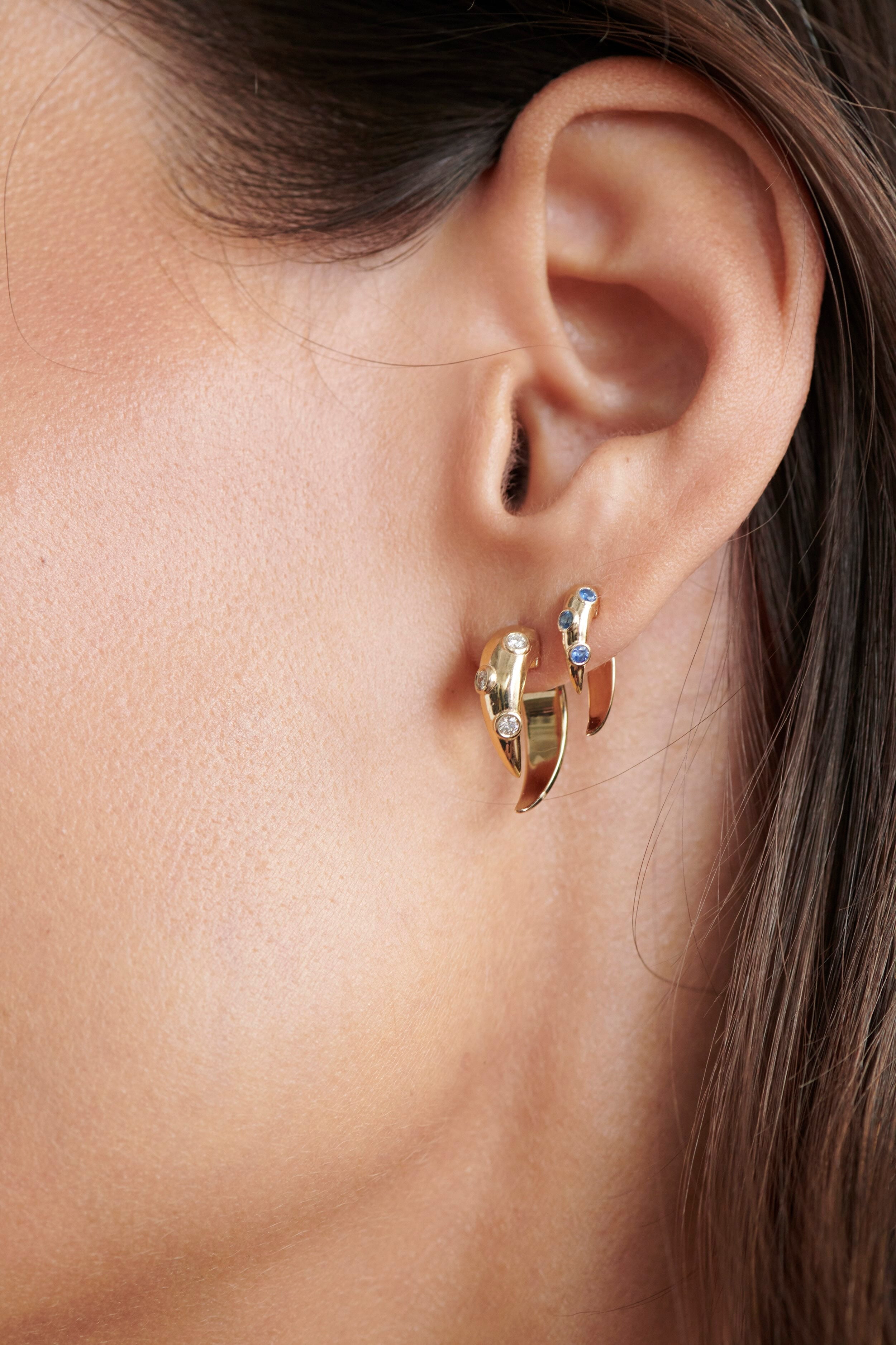 Close-up of Model Wearing Vale Jewelry Swoop Sapphire 2-Piece Earrings