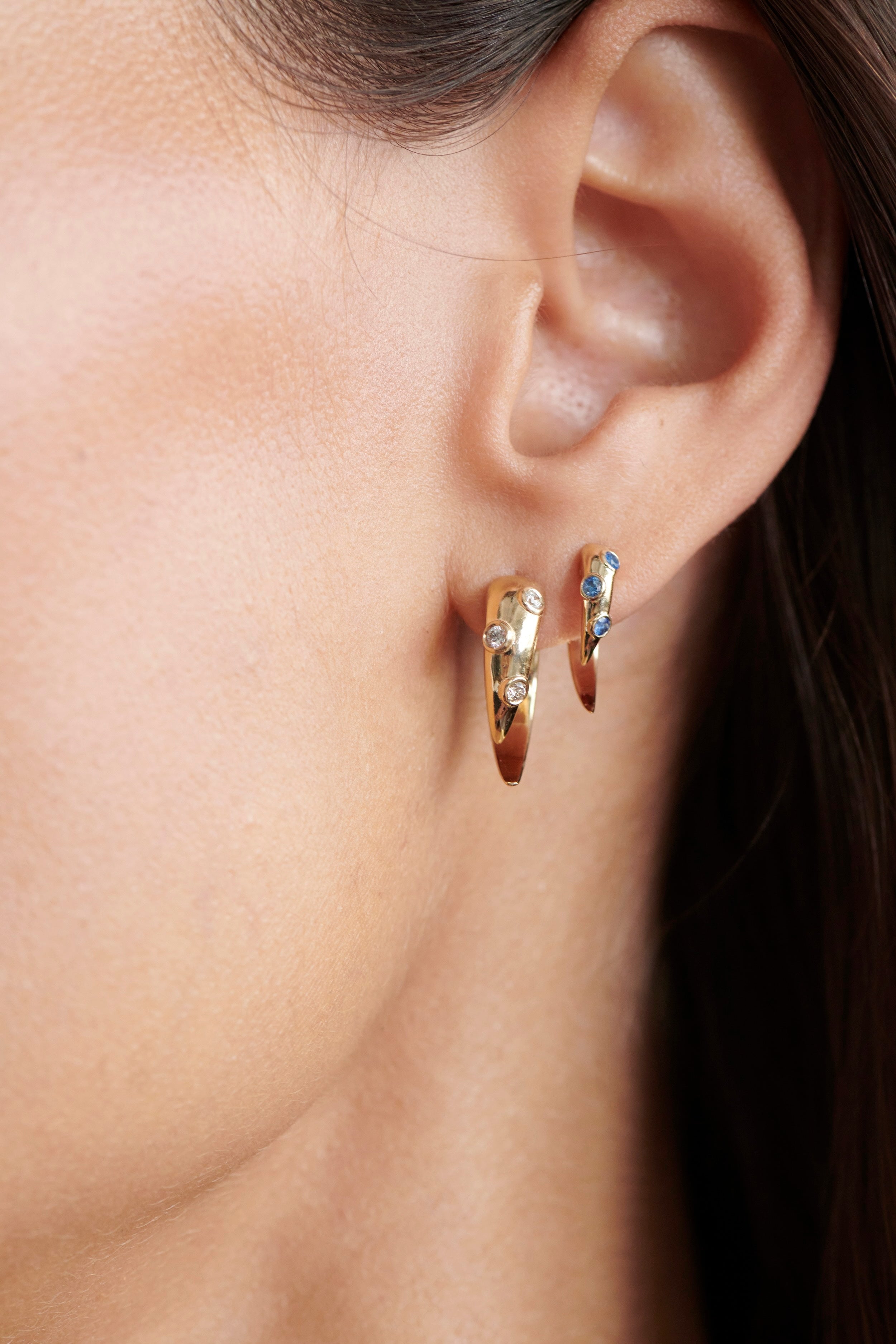 Close-up of Model Wearing Vale Jewelry Swoop Sapphire 2-Piece Earrings