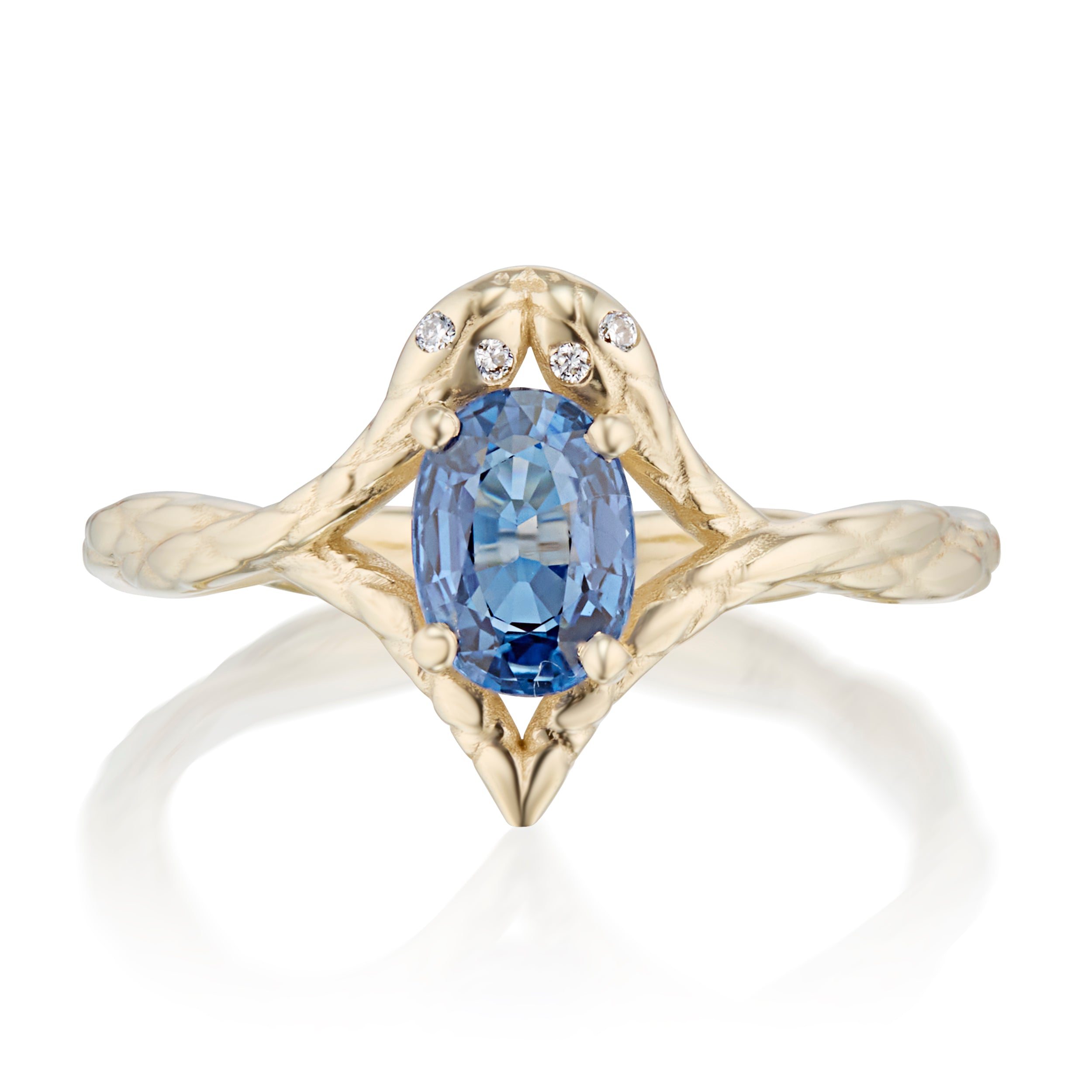 Two symmetrical snakes with a blue sapphire in an open setting in the middle ring