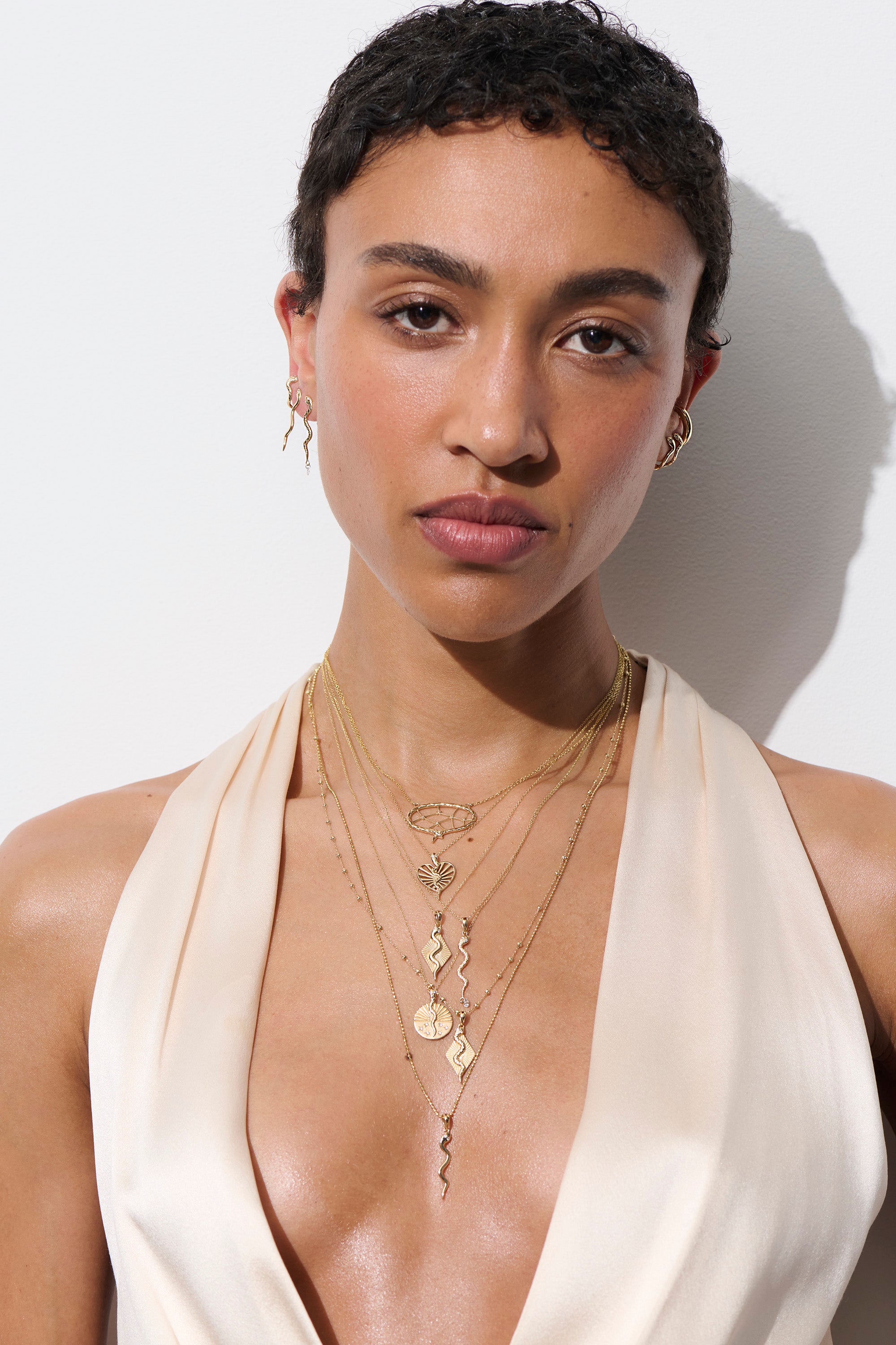 Alt="Vale Jewelry model wearing web of stars necklace and other eternals collection necklaces and earrings"