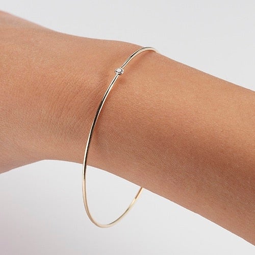 Vale Jewelry Quotidien Simple Bangle with Round Brilliant Cut White Diamond in 14 Karat Yellow Gold on Wrist